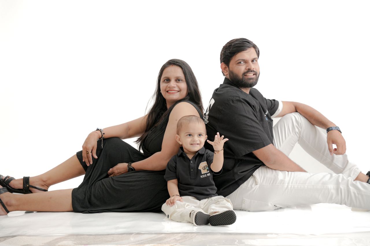 Studio portrait of a joyful family sitting together, emphasizing family bonds and unity.